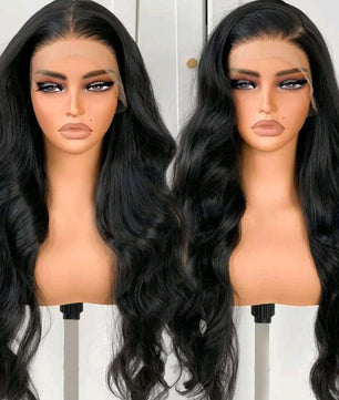 Two mannequin heads with long black wavy hair on a white background
