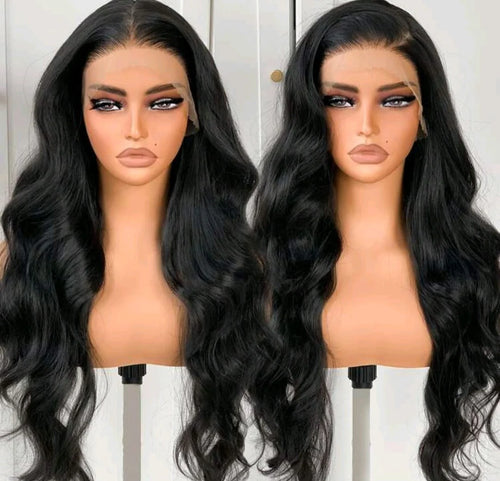 Two mannequin heads with long black wavy hair on a white background