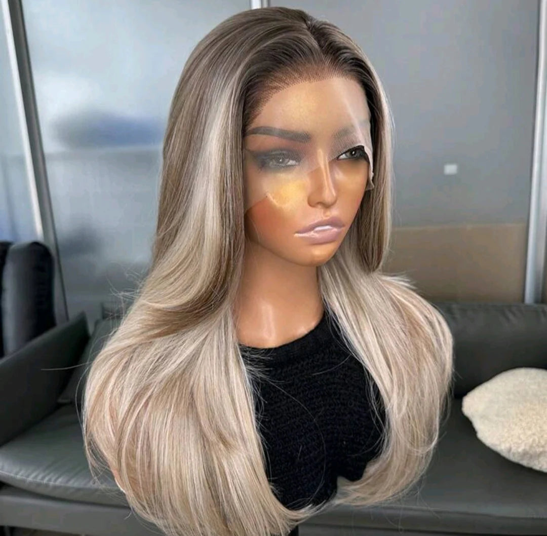 Mannequin head with a blonde wig on a blurred indoor background